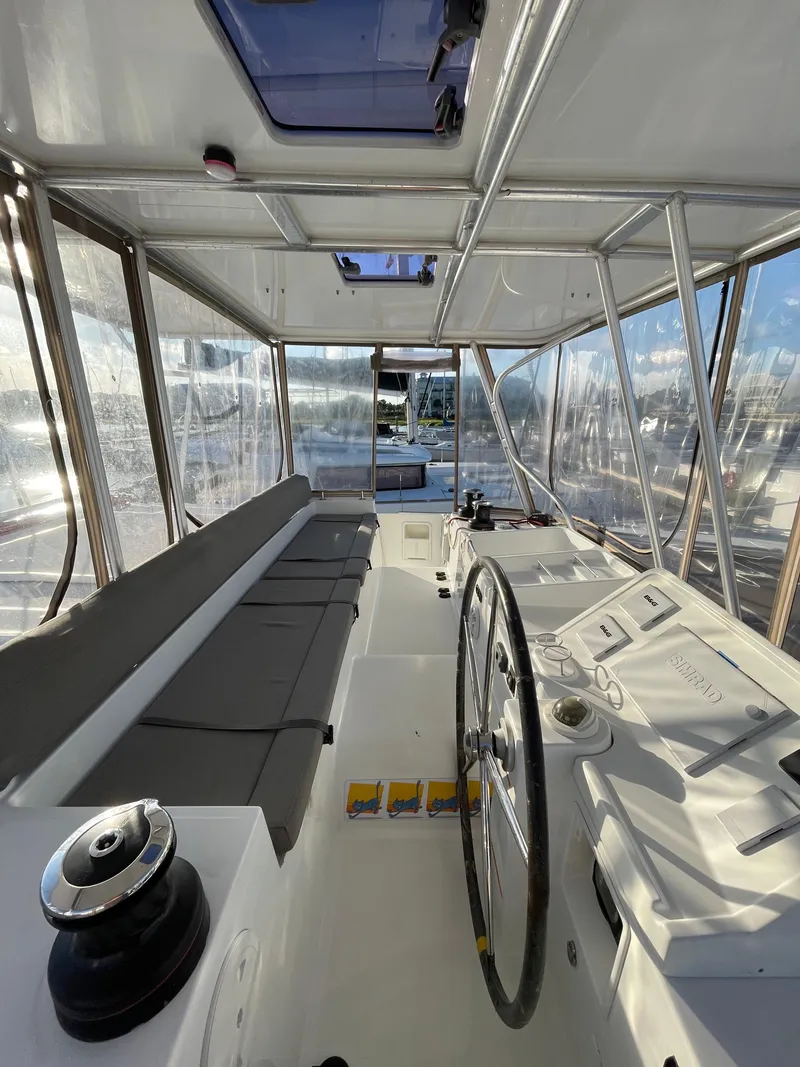 Slide: The Image of Interior view of 2016 Lagoon 450 F catamaran cockpit with steering wheel and seating. - 27