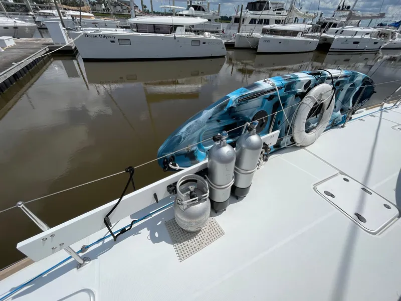 Slide: The Image of Lagoon 450 F catamaran deck with scuba tanks and kayak, docked in marina, 2016 model. - 31