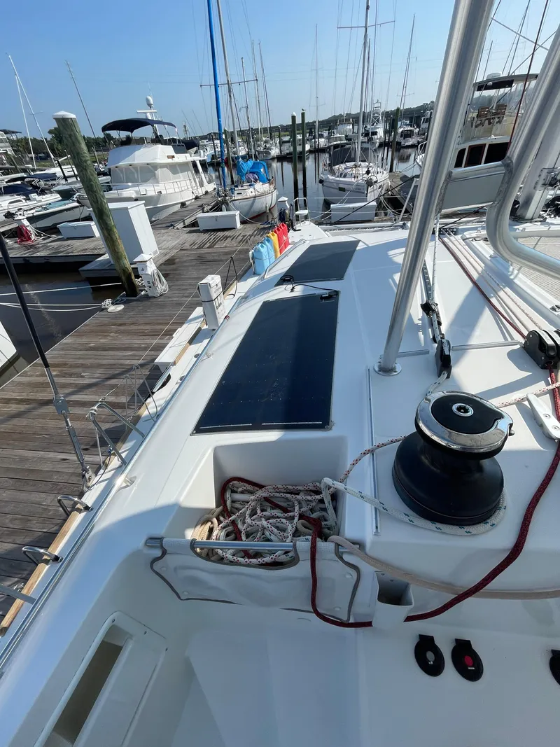 Slide: The Image of 2016 Lagoon 450 F catamaran docked at a marina, showcasing deck and winch. - 38