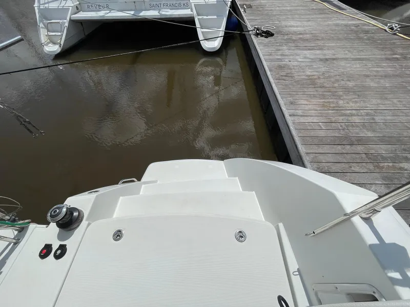 Slide: The Image of Lagoon 450 F catamaran docked at marina, view of stern and water. - 44