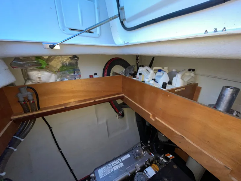 Slide: The Image of Engine compartment of a 2016 Lagoon 450 F catamaran, showing storage and mechanical components. - 45