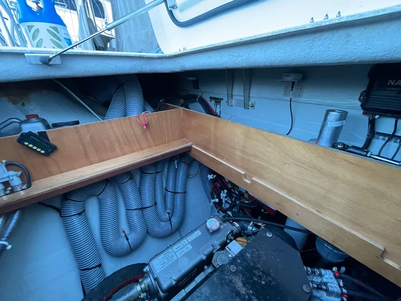 Slide: The Image of Engine compartment of a 2016 Lagoon 450 F catamaran, showcasing mechanical components and wiring. - 46