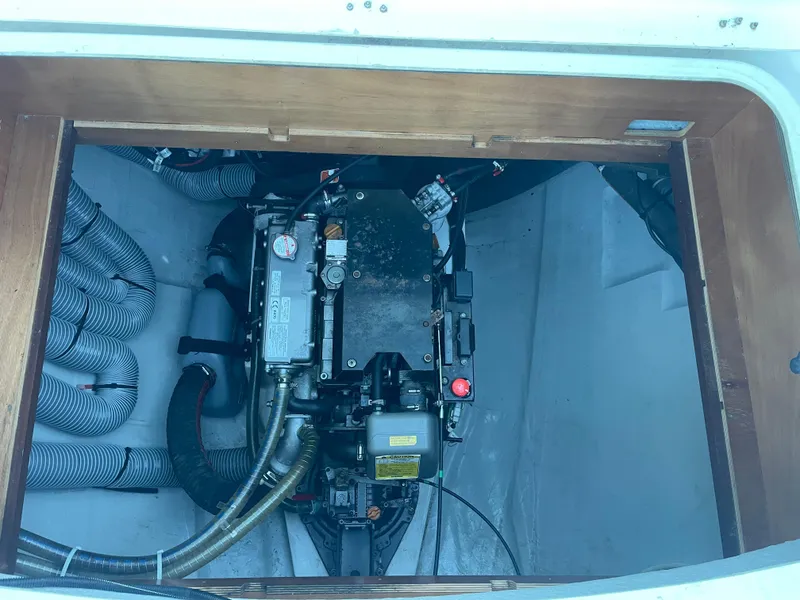 Slide: The Image of Engine compartment of a 2016 Lagoon 450 F catamaran, showcasing mechanical components and hoses. - 47
