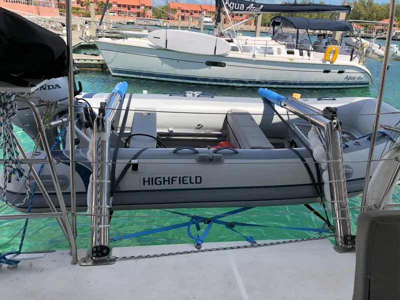 Slide: The Image of Inflatable Highfield boat on Lagoon 450 F, docked in marina, 2016 model. - 6