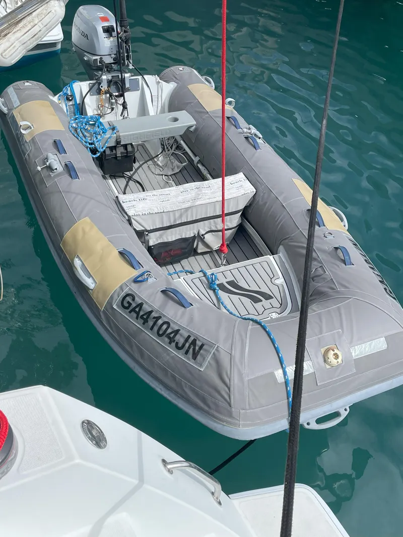 Slide: The Image of Inflatable boat docked beside a 2016 Lagoon 450 F catamaran. - 8