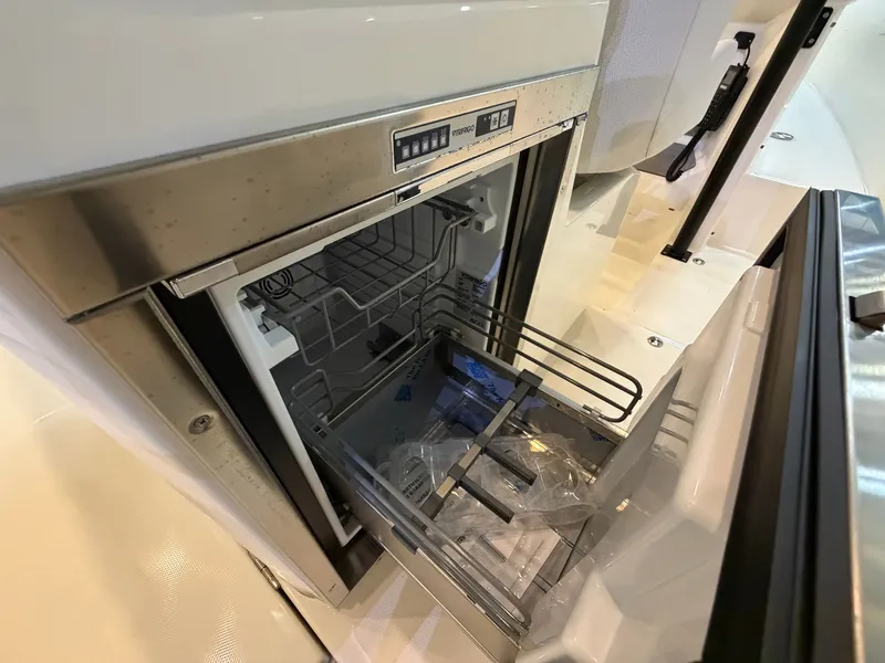 Slide: The Image of An open refrigerator with metal racks in a modern boat. - 14