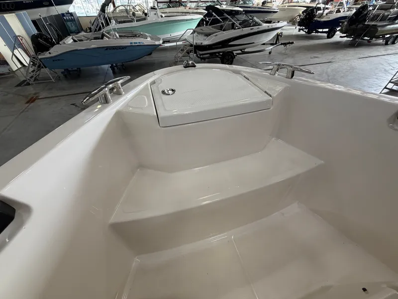 Slide: The Image of The image shows the bow of a Saxdor 320 GTO boat in a storage facility. - 18