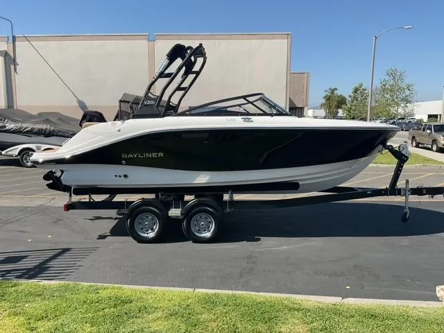 The Image of 2025 Bayliner V20i boat on trailer in parking lot, side view. - 0