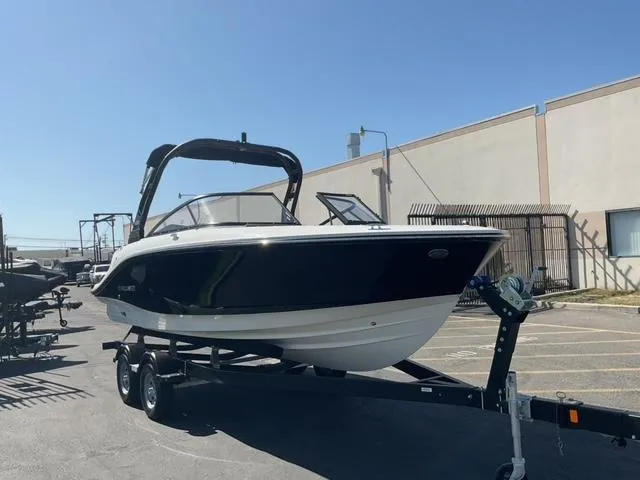 Slide: The Image of 2025 Bayliner V20i boat on trailer in sunny parking lot. - 1