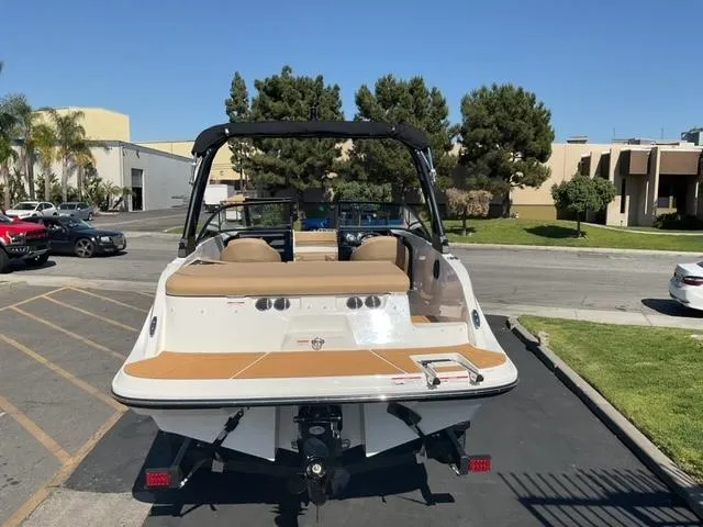 Slide: The Image of 2025 Bayliner V20i boat parked outdoors, showcasing rear view and seating area. - 10