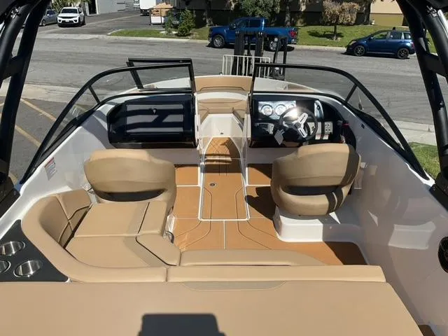 Slide: The Image of 2025 Bayliner V20i boat interior with tan seating and modern dashboard. - 12