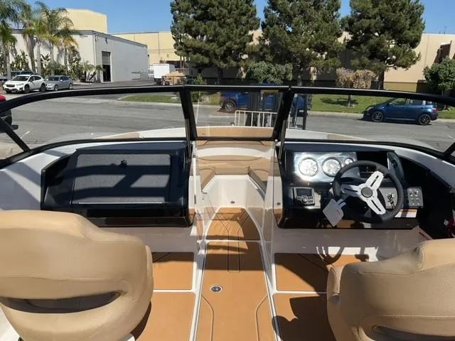 Slide: The Image of Interior view of 2025 Bayliner V20i boat with tan seats and modern dashboard. - 20