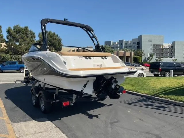 Slide: The Image of 2025 Bayliner V20i boat on trailer, parked outdoors on a sunny day. - 4