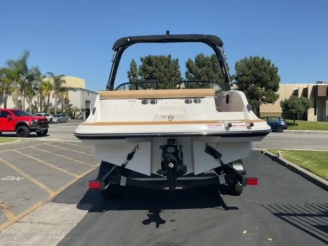 Slide: The Image of 2025 Bayliner V20i boat on trailer, parked outdoors in sunny setting. - 6