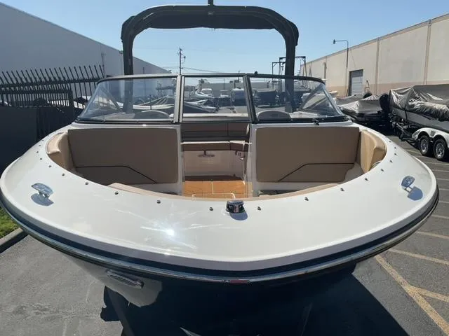 Slide: The Image of 2025 Bayliner V20i boat with open bow seating, parked outdoors. - 8