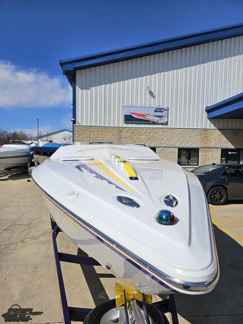 Slide: The Image of 2004 Baja 25 Outlaw speedboat displayed outdoors near a building. - 15