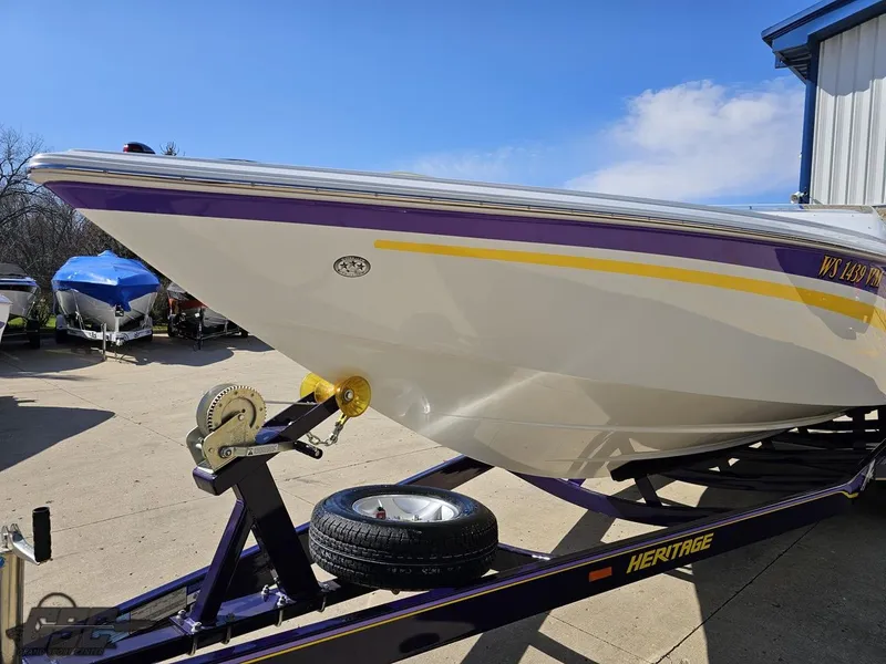 Slide: The Image of 2004 Baja 25 Outlaw boat on trailer, featuring sleek design and vibrant colors. - 16