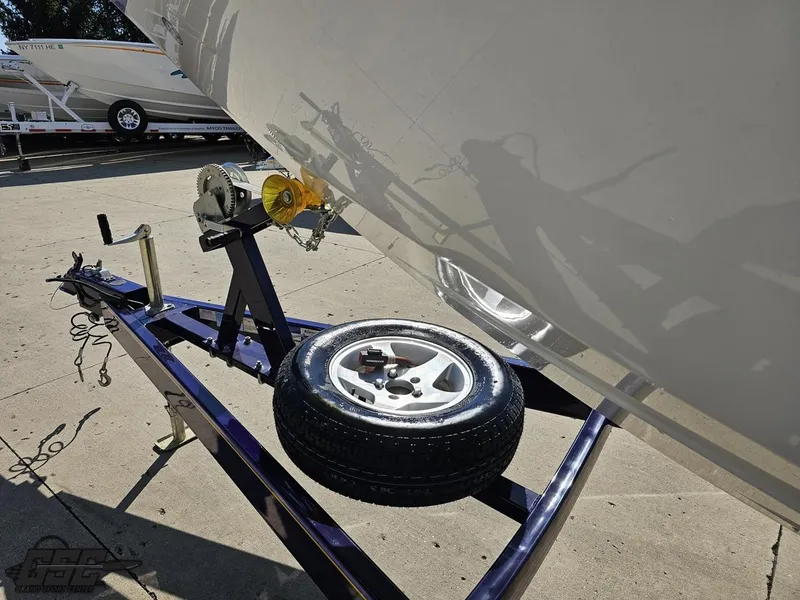 Slide: The Image of 2004 Baja 25 Outlaw boat on trailer with spare tire and winch. - 17
