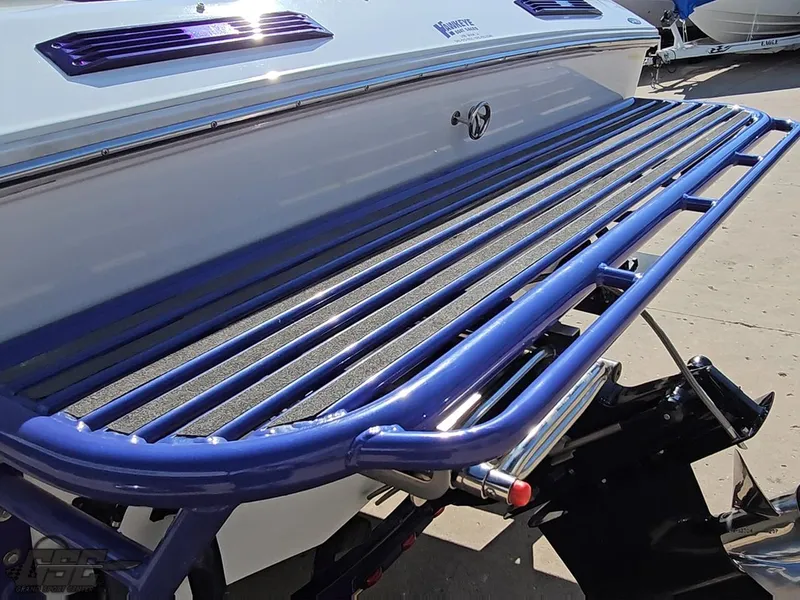 Slide: The Image of 2004 Baja 25 Outlaw boat with blue swim platform and sleek design. - 29