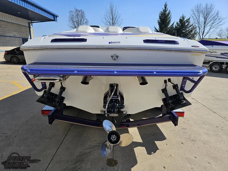 Slide: The Image of 2004 Baja 25 Outlaw boat rear view with dual propellers and purple accents. - 30