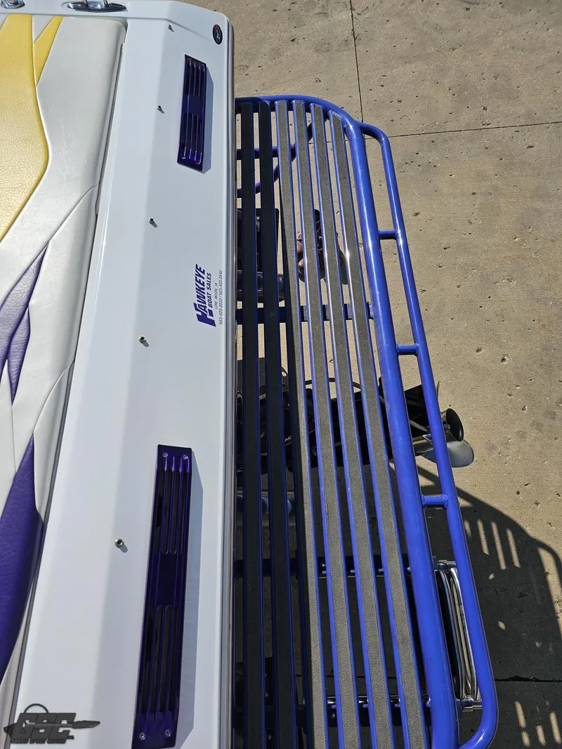 Slide: The Image of 2004 Baja 25 Outlaw boat with vibrant design and blue railing. - 35