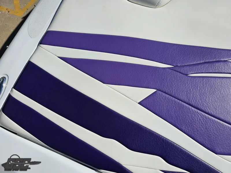 Slide: The Image of 2004 Baja 25 Outlaw boat seat with purple and white upholstery design. - 41