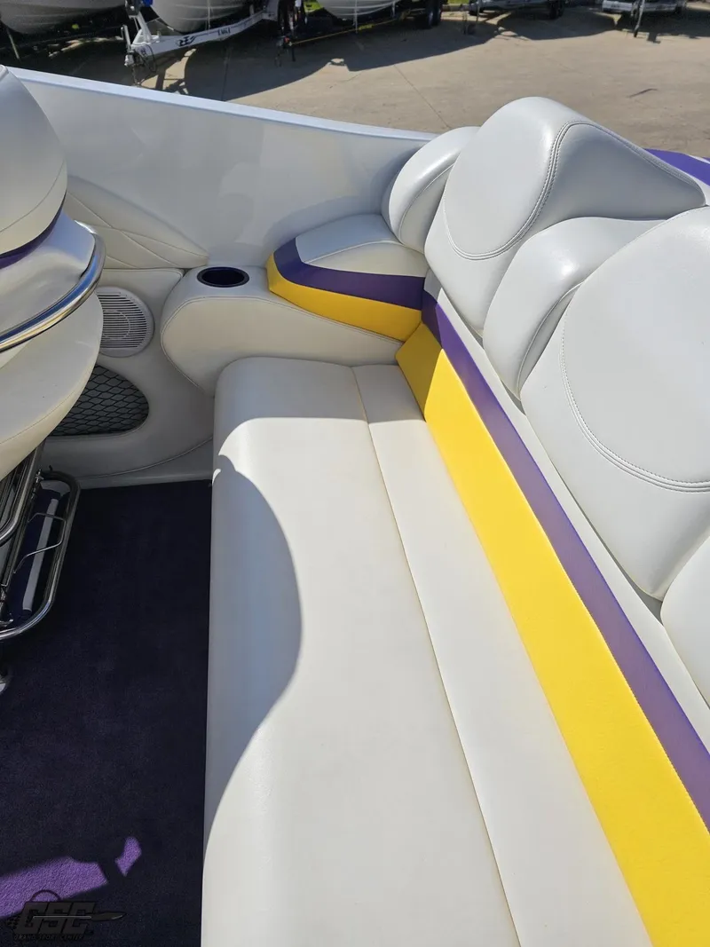 Slide: The Image of 2004 Baja 25 Outlaw boat interior with white, yellow, and purple seating. - 45