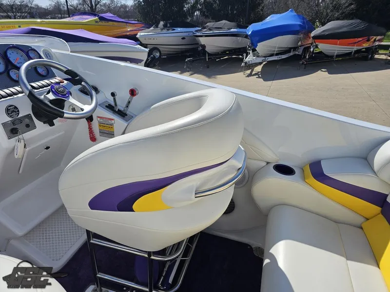 Slide: The Image of 2004 Baja 25 Outlaw boat interior with white, purple, and yellow seating. - 46