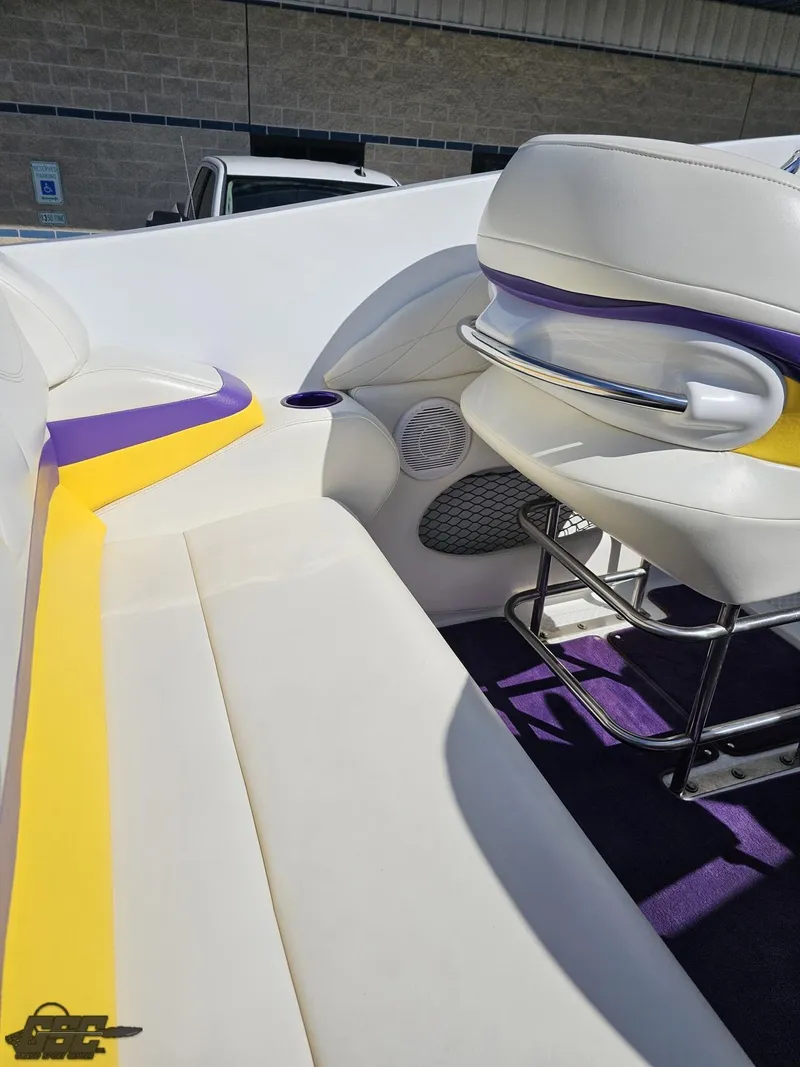 Slide: The Image of 2004 Baja 25 Outlaw boat interior with white, yellow, and purple seating. - 47