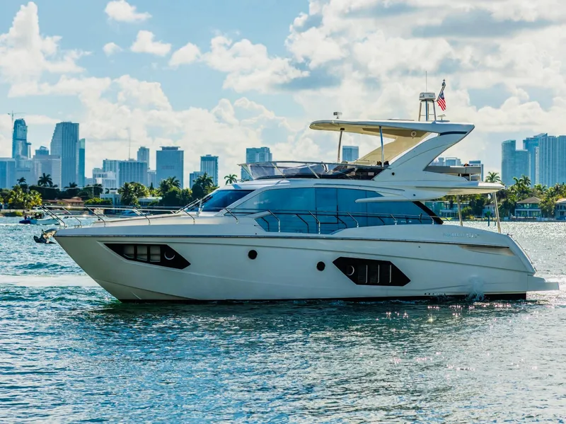 Slide: The Image of Luxury Absolute 52 FLY yacht cruising near city skyline, 2018 model. - 0