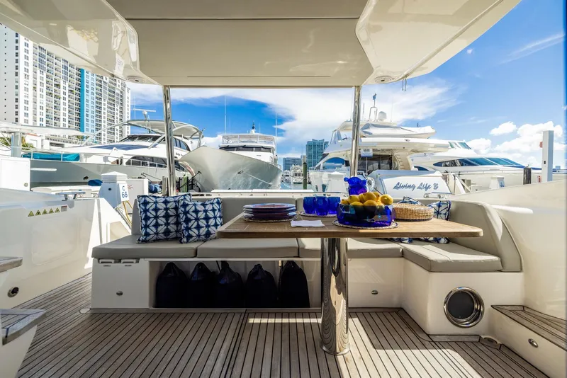 Slide: The Image of Luxurious 2018 Absolute 52 FLY yacht with elegant outdoor dining area in marina setting. - 10