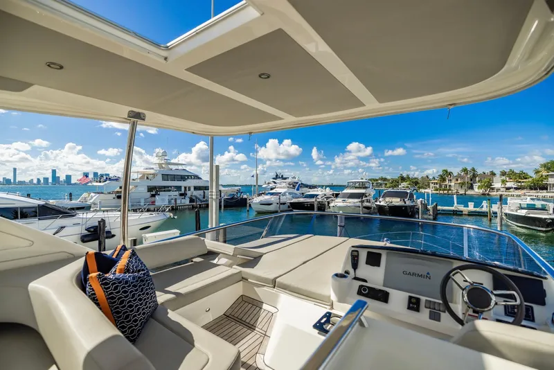 Slide: The Image of Luxurious 2018 Absolute 52 FLY yacht docked at a scenic marina under clear blue skies. - 12