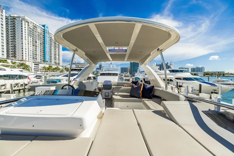 Slide: The Image of Luxurious 2018 Absolute 52 FLY yacht with spacious deck, docked in a marina. - 14