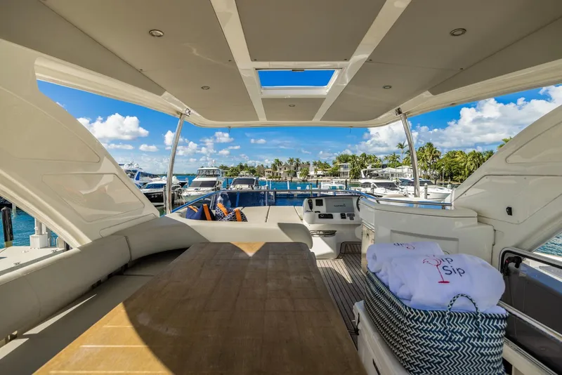 Slide: The Image of Luxurious 2018 Absolute 52 FLY yacht interior with marina view and elegant seating area. - 15