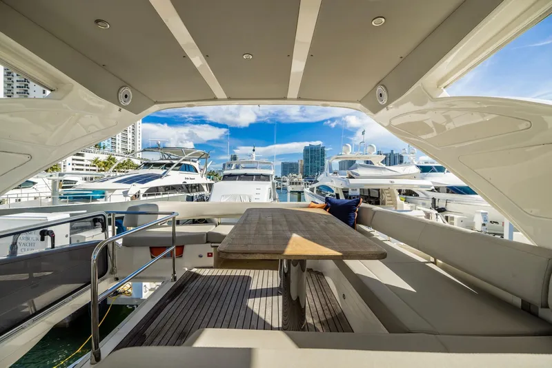 Slide: The Image of Luxurious 2018 Absolute 52 FLY yacht interior with spacious seating and marina view. - 16