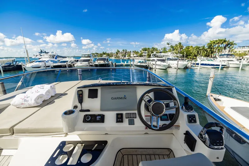 Slide: The Image of Flybridge view of 2018 Absolute 52 FLY yacht docked at marina, clear skies. - 17