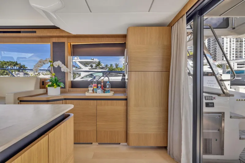 Slide: The Image of Luxurious interior of 2018 Absolute 52 FLY yacht with modern wood cabinetry and scenic window view. - 20