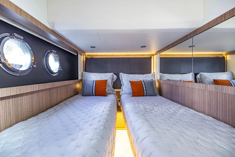 Slide: The Image of Luxurious twin cabin in 2018 Absolute 52 FLY yacht with modern decor and porthole windows. - 33