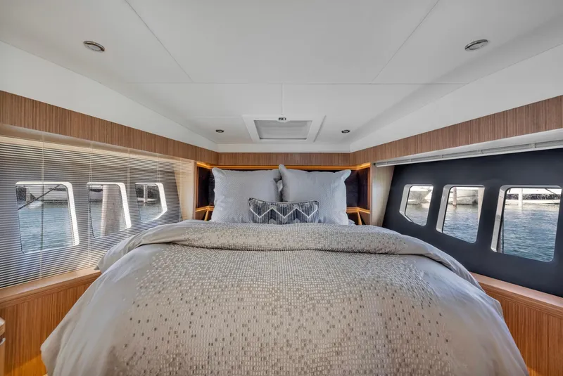 Slide: The Image of Luxurious bedroom interior of 2018 Absolute 52 FLY yacht with elegant bedding and panoramic windows. - 34