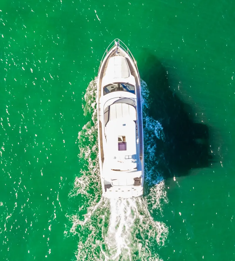 Slide: The Image of Aerial view of 2018 Absolute 52 FLY yacht cruising in vibrant green waters. - 5