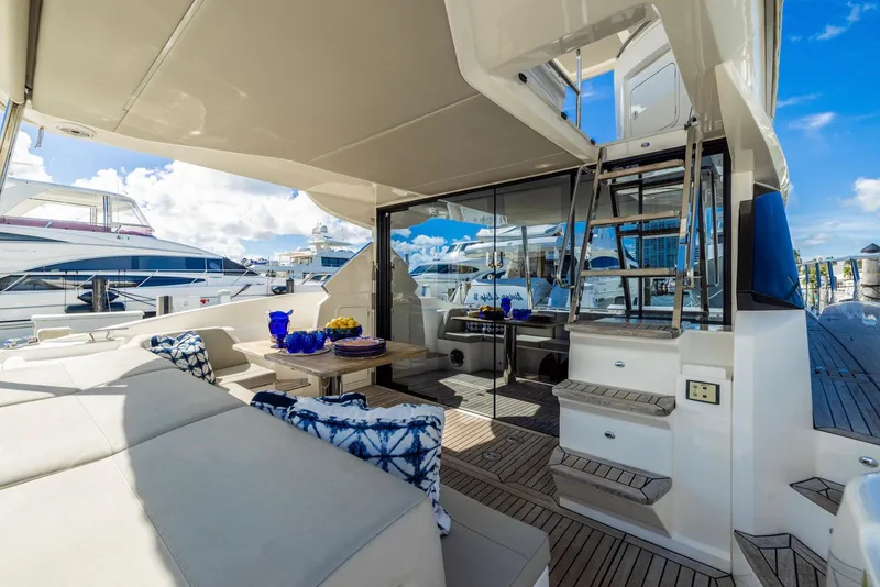 Slide: The Image of Luxurious 2018 Absolute 52 FLY yacht with elegant outdoor seating and dining area. - 8