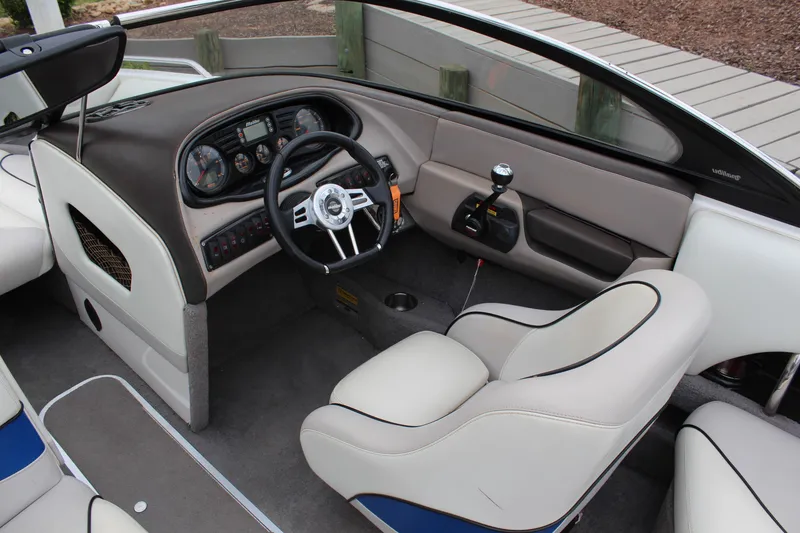 Slide: The Image of 2006 Malibu Sunscape 21 LSV boat interior with steering wheel and dashboard. - 11