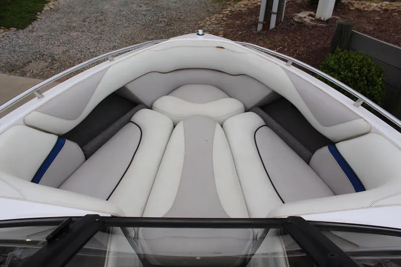 Slide: The Image of 2006 Malibu Sunscape 21 LSV boat interior with white cushioned seating. - 13