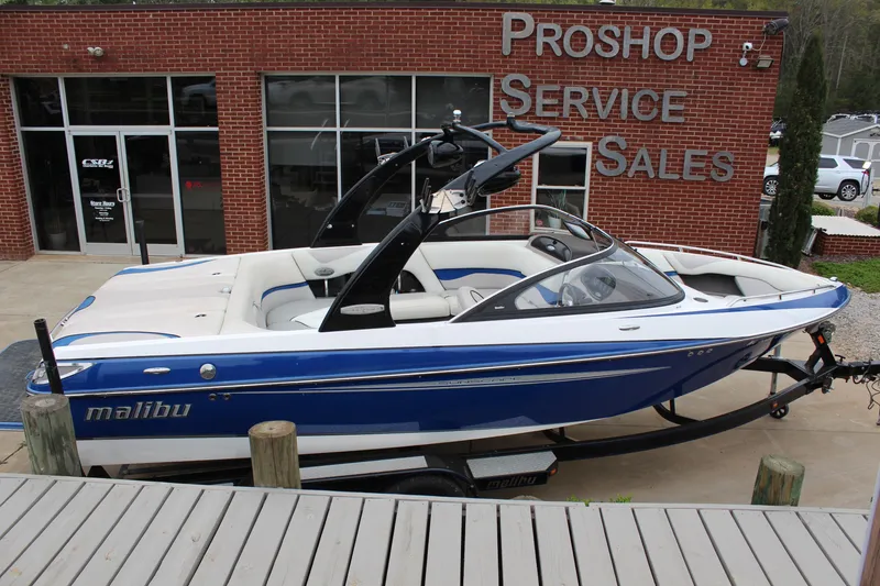 Slide: The Image of 2006 Malibu Sunscape 21 LSV boat displayed outside a pro shop. - 6