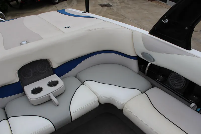 Slide: The Image of Interior seating of a 2006 Malibu Sunscape 21 LSV boat with cup holders and speakers. - 9