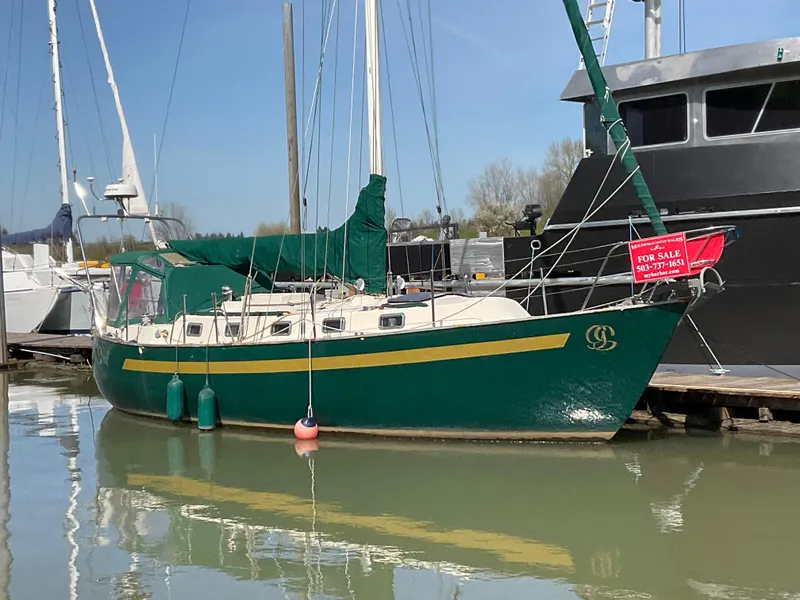 The Image of 1984 Clearwater Cutter sailboat docked, green hull, for sale sign visible. - 0