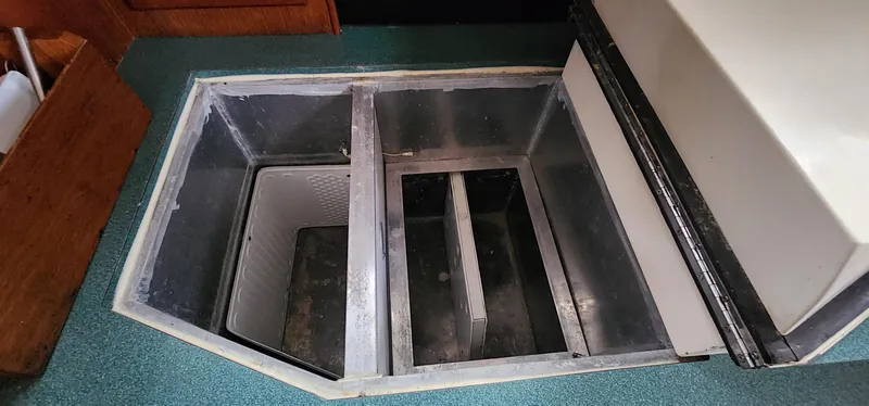 Slide: The Image of Open storage compartment on 1984 Clearwater Cutter boat with divided sections. - 11