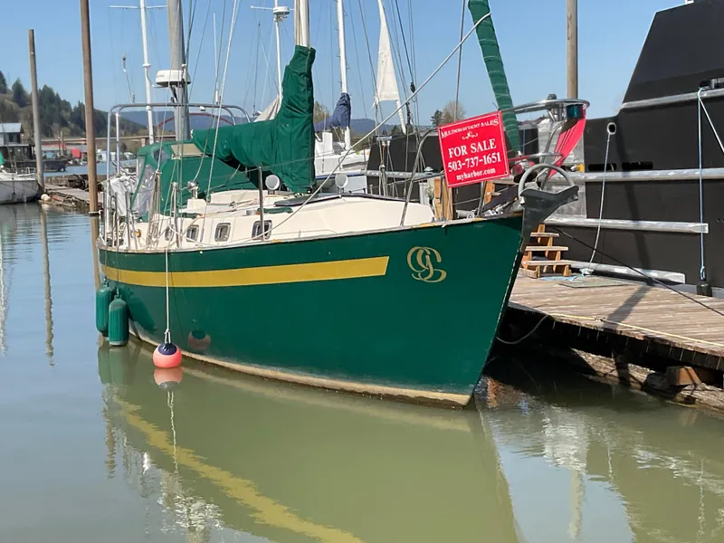 Slide: The Image of 1984 Clearwater Cutter sailboat docked, green hull, for sale sign displayed. - 2