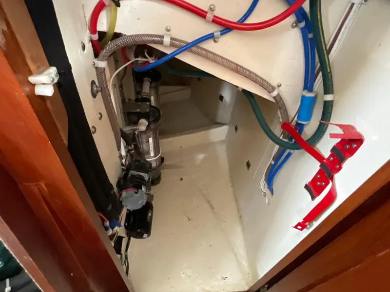Slide: The Image of Engine compartment of a 1984 Clearwater Cutter boat with visible wiring and components. - 28