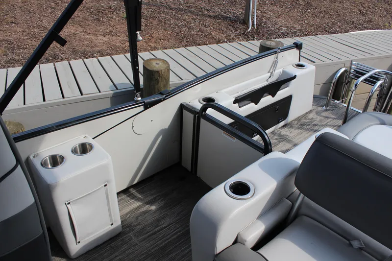 Slide: The Image of 2023 Tahoe Pontoon Cascade Platinum Versatile Rear Bench interior with cup holders and seating. - 10